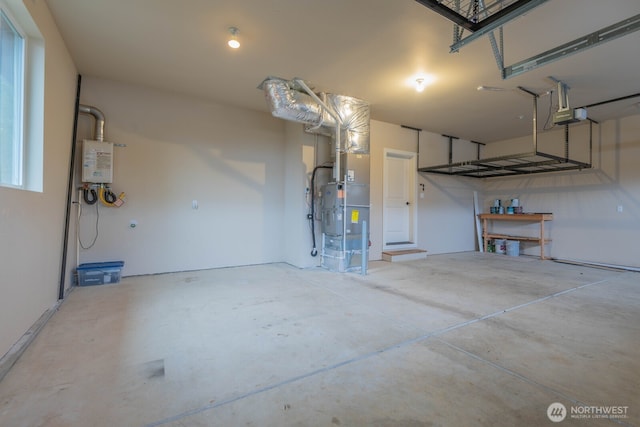 garage featuring heating unit, tankless water heater, and a garage door opener