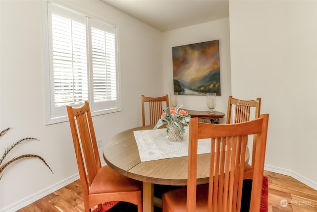 dining space with light hardwood / wood-style floors