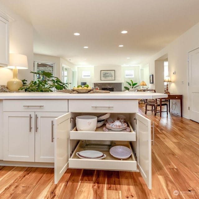 interior space with plenty of natural light, light hardwood / wood-style flooring, and white cabinets