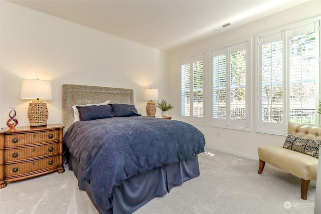 bedroom featuring light carpet