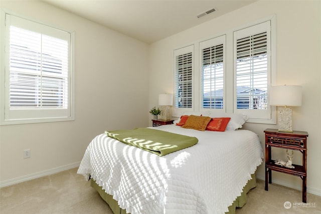 bedroom featuring light colored carpet