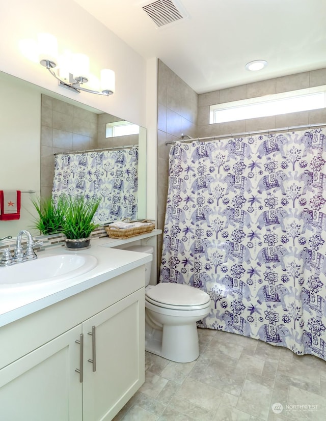 bathroom with vanity, a shower with curtain, and toilet