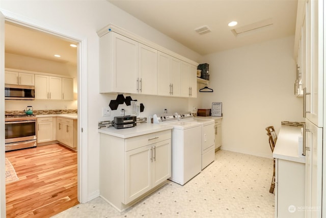 clothes washing area featuring independent washer and dryer