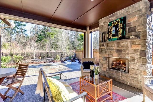 view of patio featuring an outdoor stone fireplace