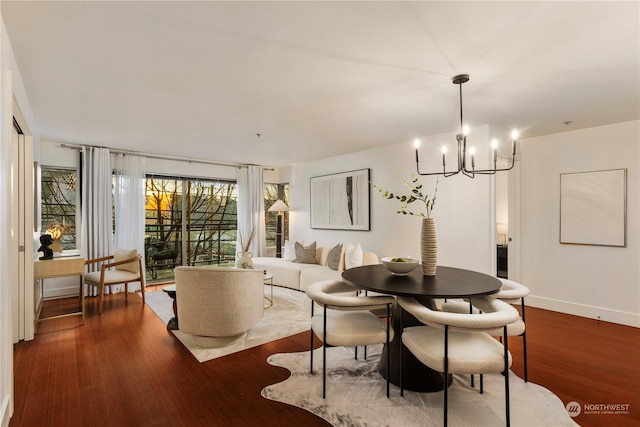 dining room featuring dark wood-type flooring and a chandelier