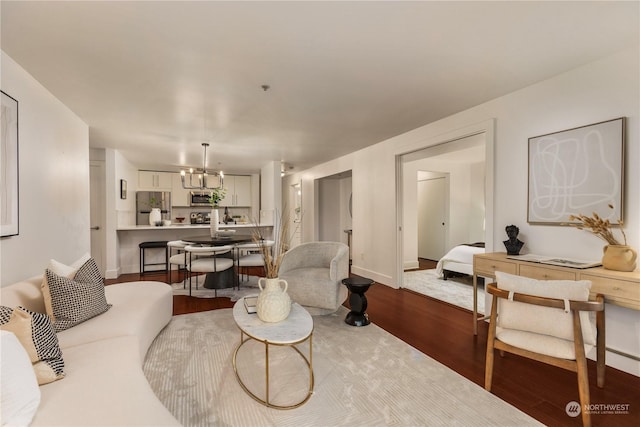 living room featuring hardwood / wood-style flooring and a chandelier