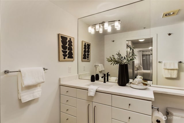 bathroom with vanity and toilet