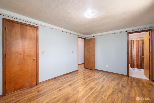 unfurnished bedroom featuring light hardwood / wood-style floors and a textured ceiling