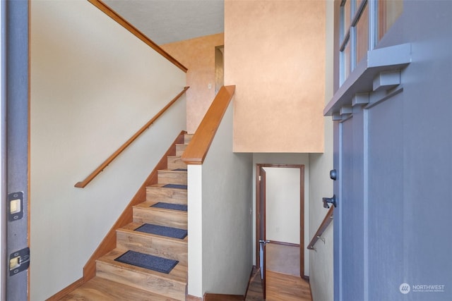 stairs with hardwood / wood-style floors