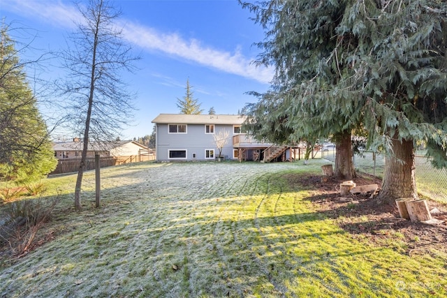 rear view of property featuring a lawn