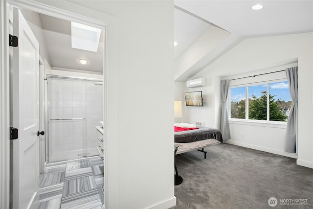 bedroom featuring baseboards, connected bathroom, lofted ceiling, a wall mounted air conditioner, and carpet floors