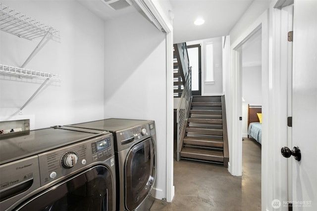 laundry room with laundry area, separate washer and dryer, and recessed lighting