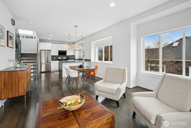 living room with a healthy amount of sunlight, dark wood-style flooring, and recessed lighting