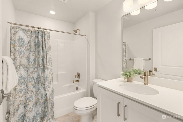 full bathroom with tile patterned flooring, vanity, toilet, and shower / bath combo with shower curtain