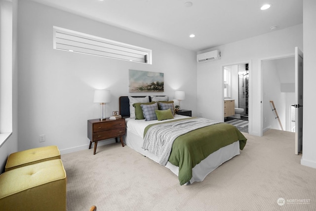 carpeted bedroom featuring ensuite bath and a wall mounted AC