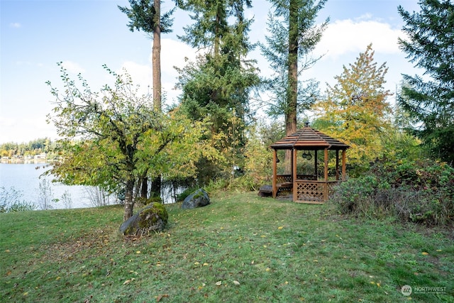 view of yard featuring a gazebo and a water view