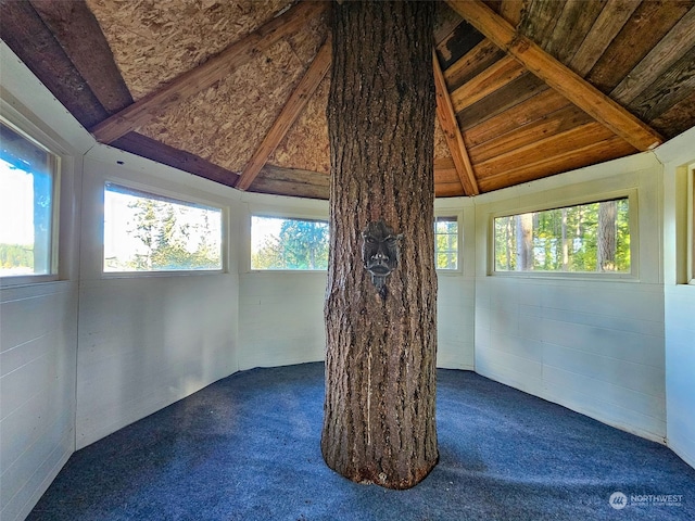 interior space with a healthy amount of sunlight, vaulted ceiling with beams, and wood ceiling