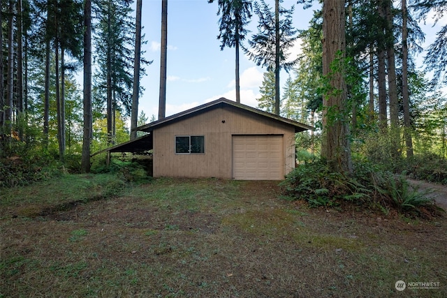 view of side of property featuring a garage and an outdoor structure