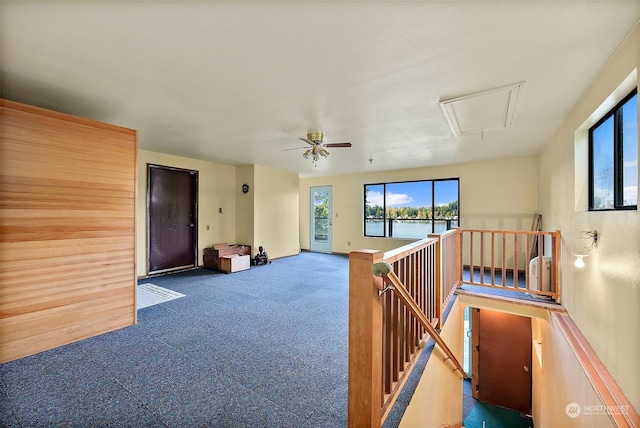 interior space with ceiling fan