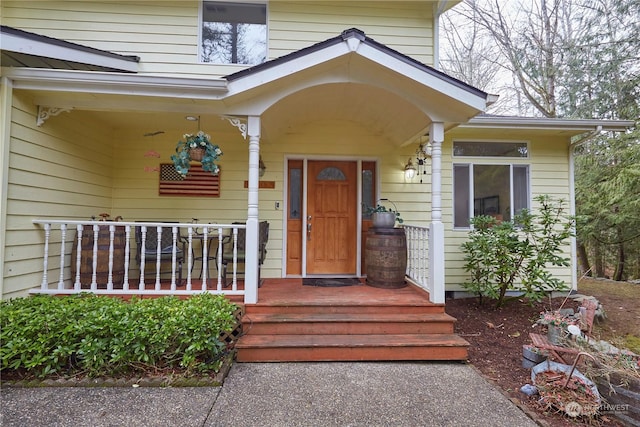 view of exterior entry with covered porch