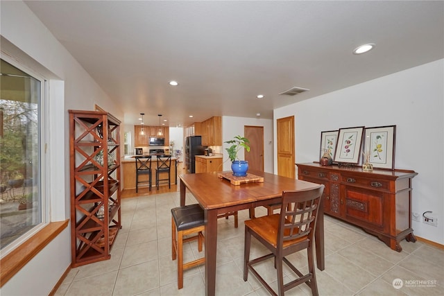 dining room with light tile patterned flooring