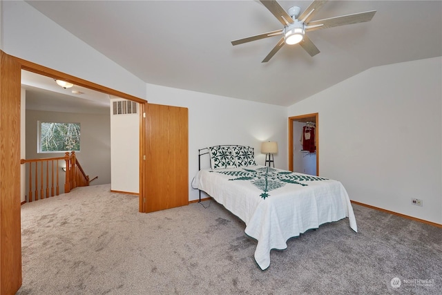 bedroom with ceiling fan, carpet floors, and vaulted ceiling