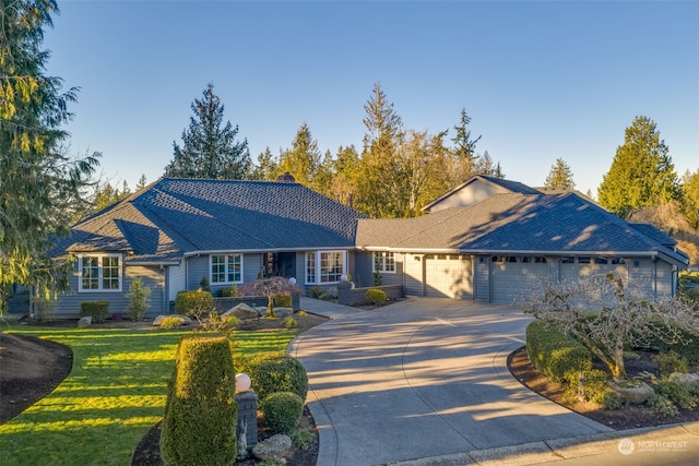 ranch-style house with a garage and a front lawn