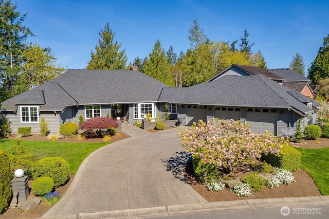 ranch-style home with aphalt driveway and a garage