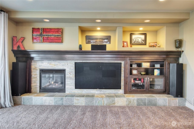 interior details featuring a fireplace and carpet flooring