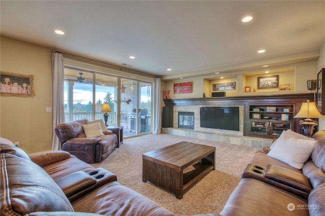 carpeted living room featuring a stone fireplace