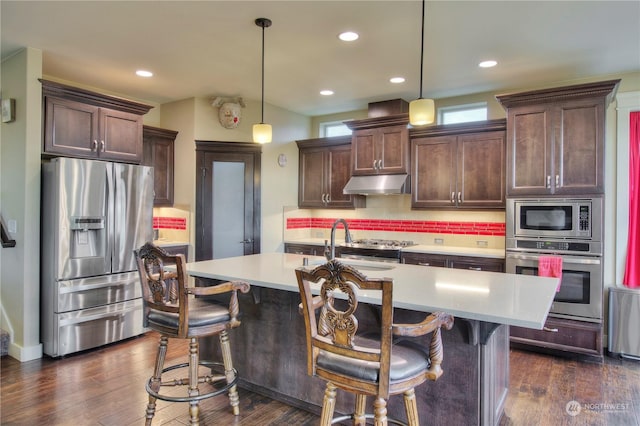 kitchen with stainless steel appliances, hanging light fixtures, and dark brown cabinets