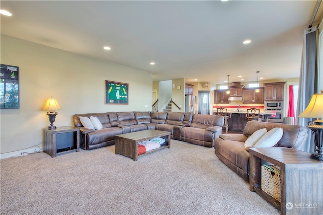 living room featuring sink and light colored carpet