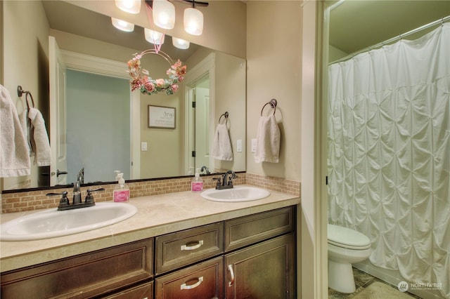 bathroom featuring vanity, decorative backsplash, toilet, and walk in shower