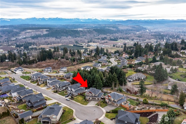 birds eye view of property with a mountain view