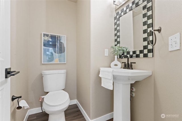 bathroom with wood-type flooring and toilet