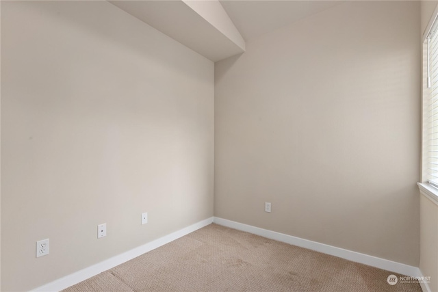 unfurnished room featuring light colored carpet