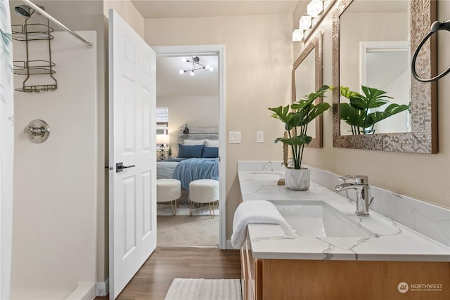 bathroom with vanity, hardwood / wood-style floors, and a shower