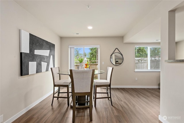 dining space featuring wood-type flooring