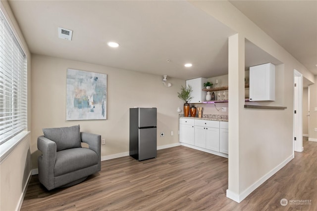 sitting room featuring dark wood-type flooring