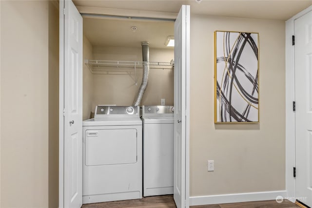 laundry area with hardwood / wood-style floors and washing machine and dryer