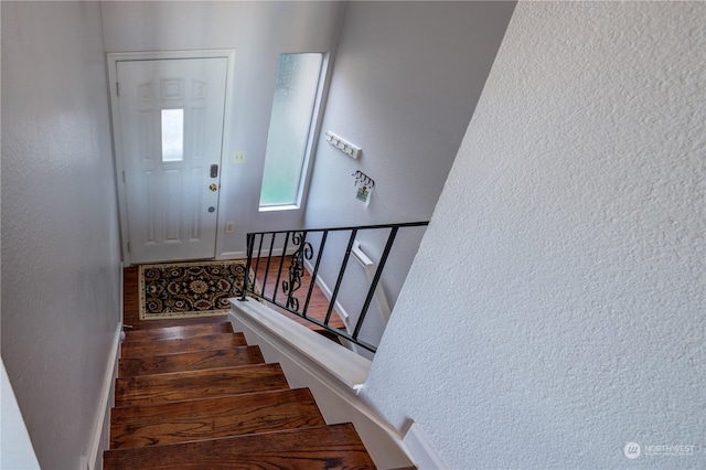 stairs with wood-type flooring