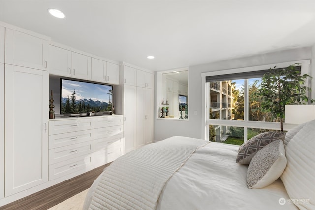 bedroom with dark hardwood / wood-style flooring