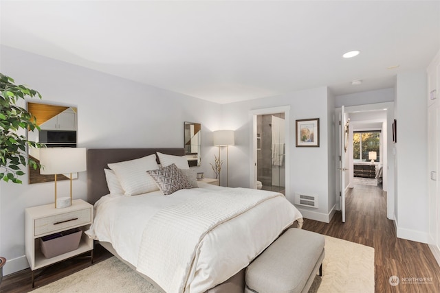 bedroom featuring dark hardwood / wood-style floors and connected bathroom