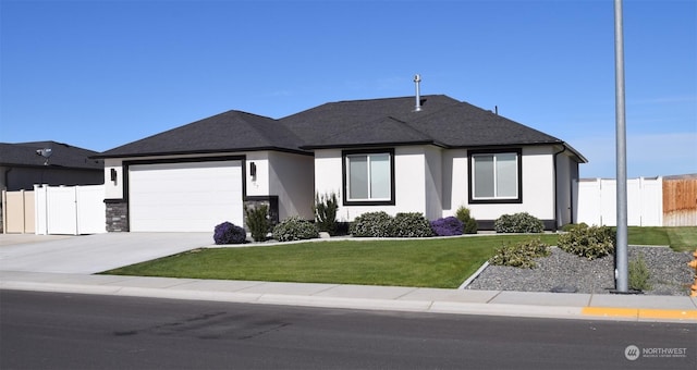 view of front of house featuring a garage and a front yard