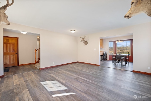 unfurnished room featuring dark hardwood / wood-style floors and a notable chandelier