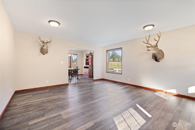 empty room with dark hardwood / wood-style floors