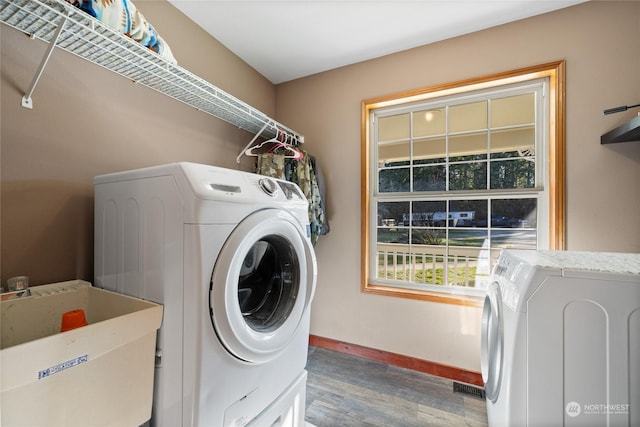 washroom featuring hardwood / wood-style flooring, sink, and washer and dryer