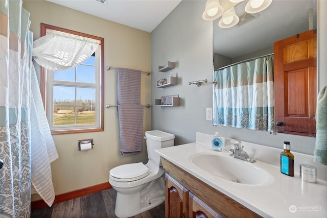 bathroom featuring vanity, hardwood / wood-style floors, toilet, and walk in shower