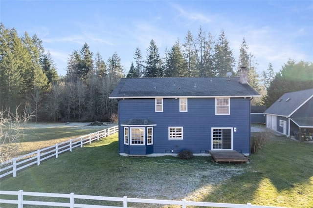 rear view of property featuring a yard