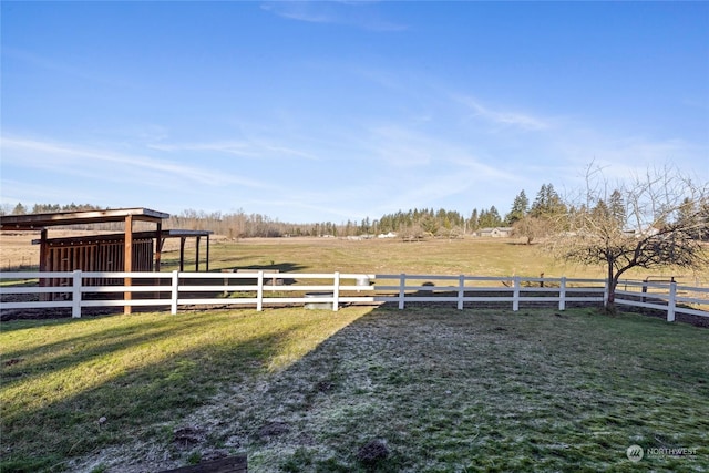 view of yard featuring a rural view and an outdoor structure